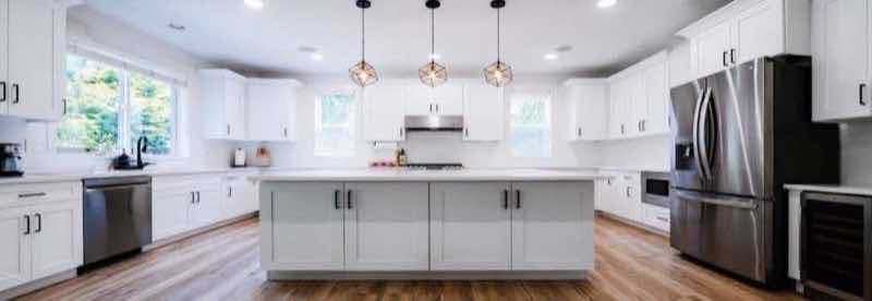Bright white shaker kitchen with island and stainless appliances