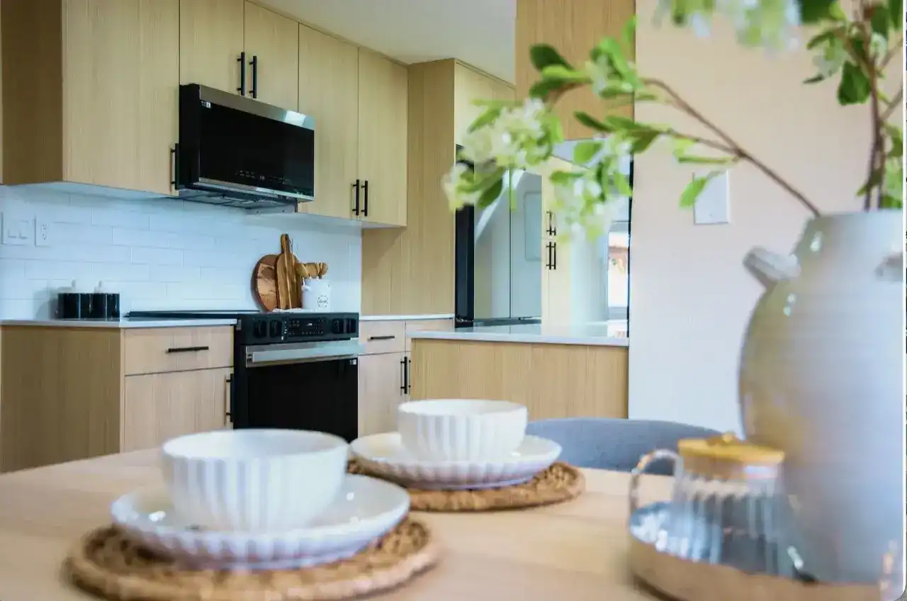 Light wood Scandinavian-style kitchen cabinetry with white subway backsplash